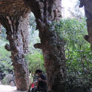 A guitarist playing beside the pillar